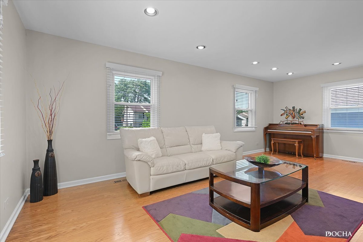 165 Stonegate Road Buffalo Grove, IL 60089 - Photo 5 of 25 a living room with furniture a bed and a window