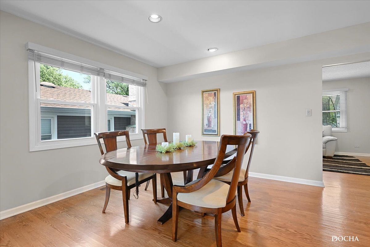 165 Stonegate Road Buffalo Grove, IL 60089 - Photo 7 of 25 a view of a dining room with furniture window and wooden floor