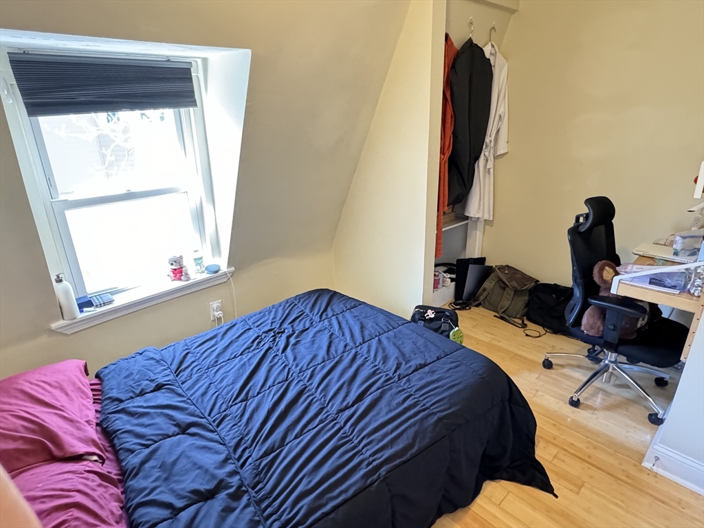 5 St James Place, Unit 5 Boston, MA 02119 - Photo 11 of 12 a bedroom with a bed and a window