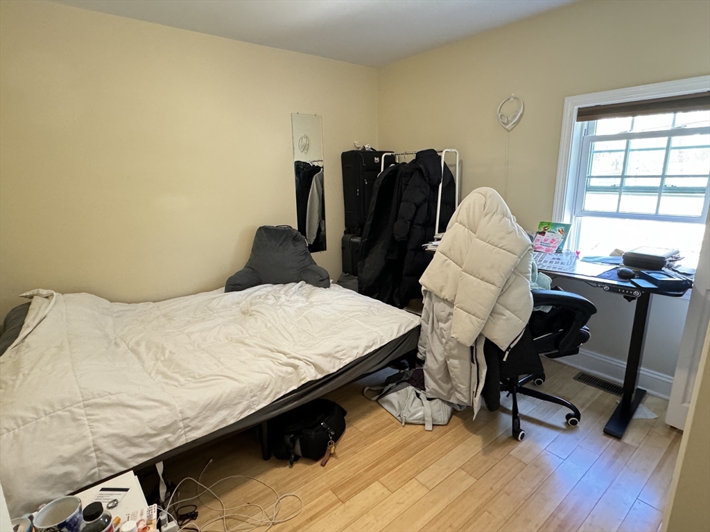 5 St James Place, Unit 5 Boston, MA 02119 - Photo 12 of 12 a bed sitting in a bedroom next to a window