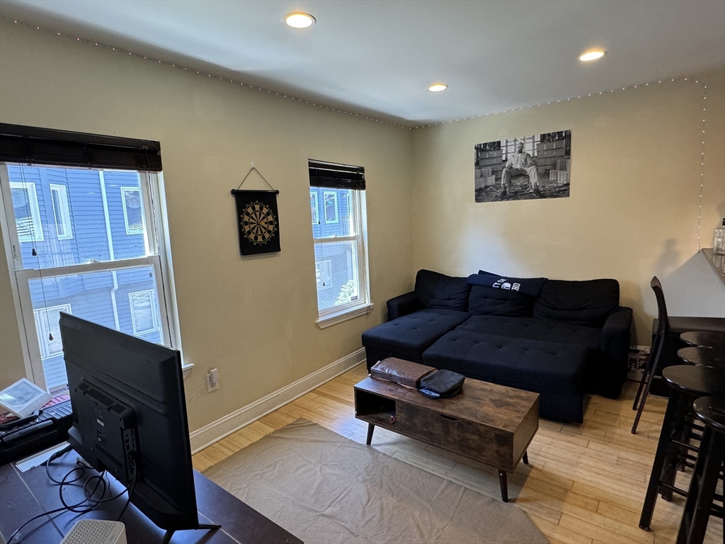 5 St James Place, Unit 5 Boston, MA 02119 - Photo 4 of 12 a living room with furniture and a fireplace