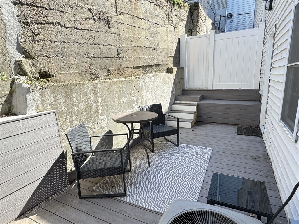 5 St James Place, Unit 5 Boston, MA 02119 - Photo 6 of 12 a balcony with table and chairs