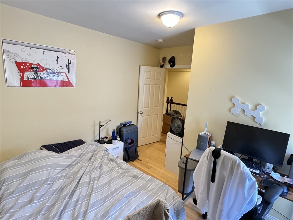 5 St James Place, Unit 5 Boston, MA 02119 - Photo 10 of 12 a bedroom with a bed and a flat screen tv