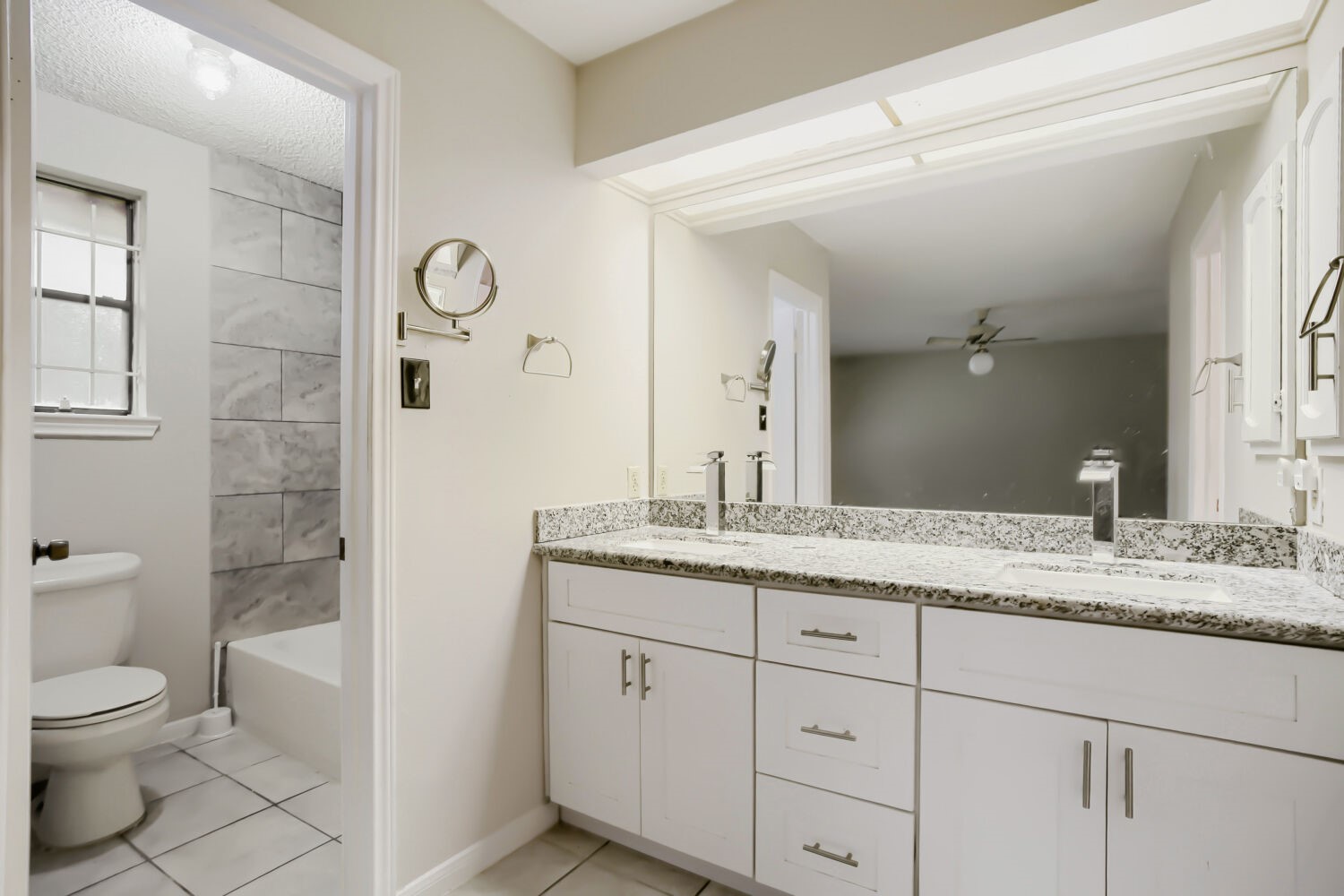 10103 Inwood Shadows Street Houston, TX 77088 - Photo 18 of 32 a bathroom with a granite countertop sink mirror and toilet