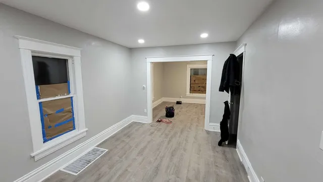 a view of an empty room with wooden floor