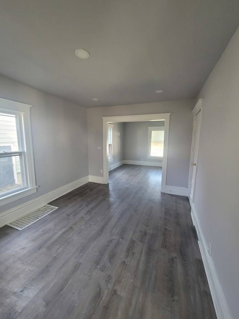 441 North View Street Aurora, IL 60506 - Photo 7 of 15 an empty room with wooden floor and windows