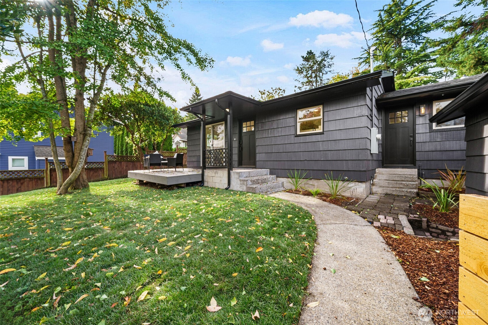 a front view of a house with a garden
