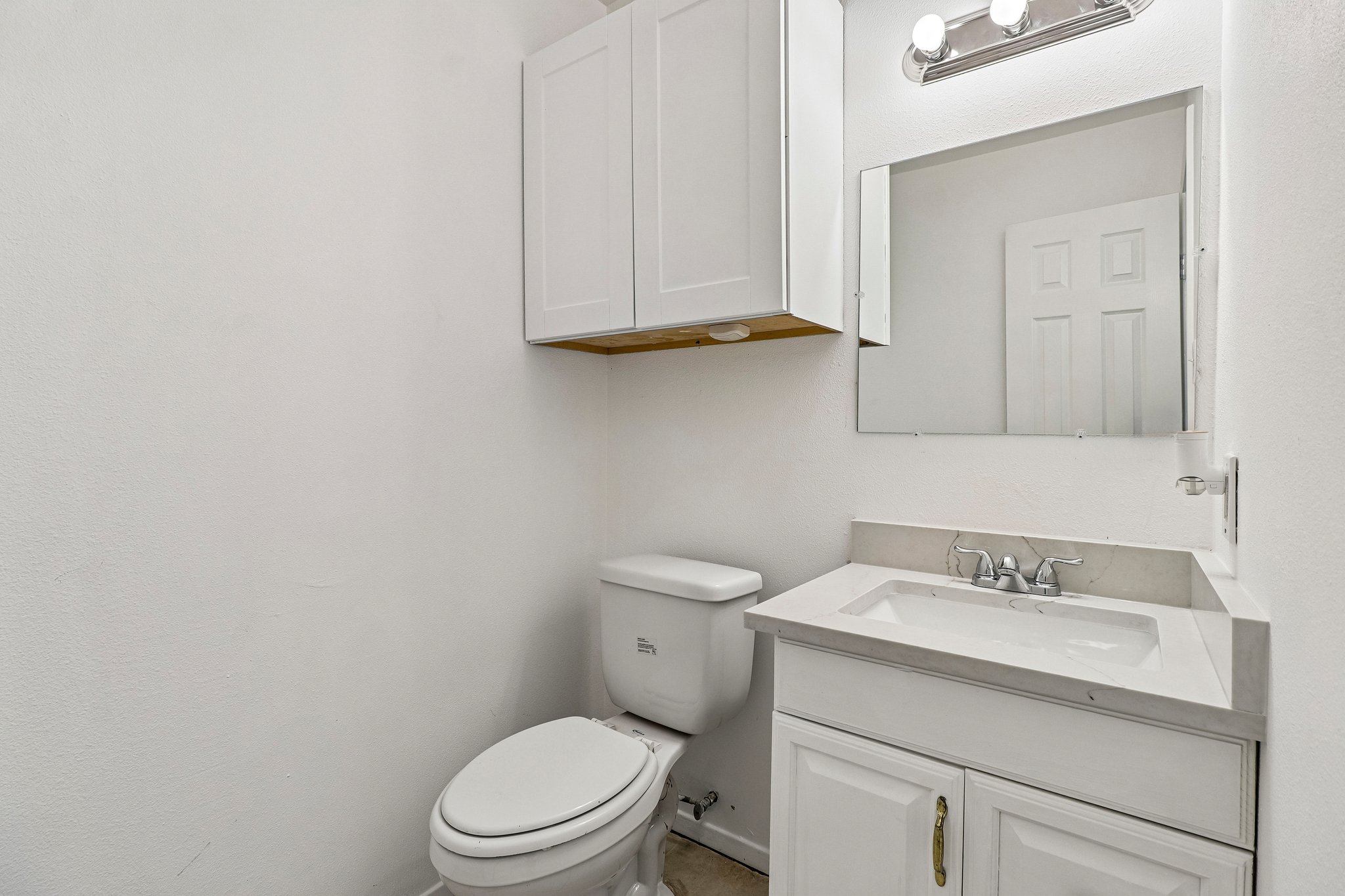5809 Coventry Lane Austin, TX 78723 - Photo 13 of 35 Down stairs, half bath features a vanity with stone counters