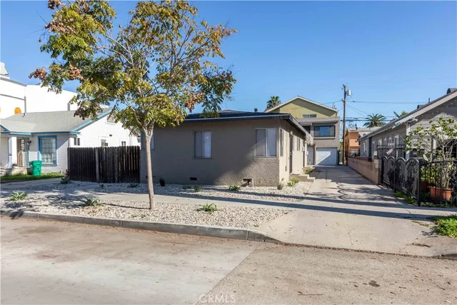 a view of a house with a snow on the road and a yard