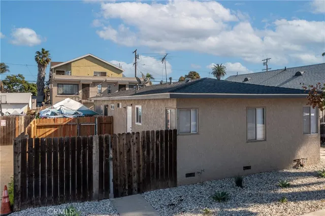 a front view of a house with wooden fence