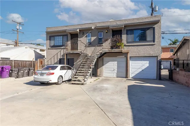 a car parked in front of white building