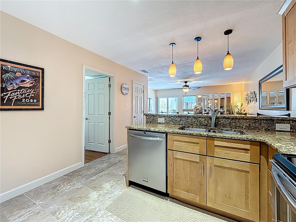 230 Medallion Boulevard, Unit G Madeira Beach, FL 33708 - Photo 9 of 38 a kitchen with cabinets and window