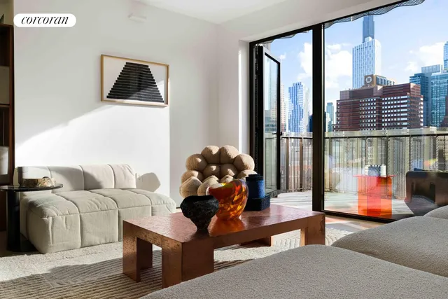a view of a livingroom with furniture and a large window