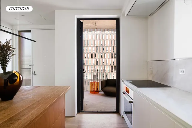 a kitchen with a sink a stove and chairs