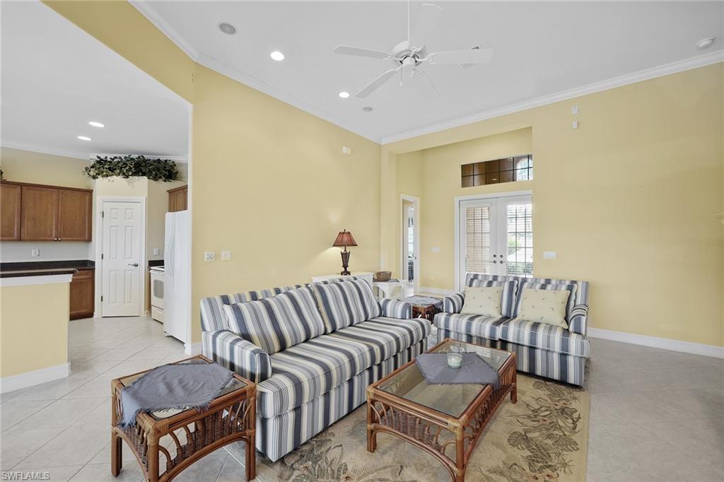 6921 Bent Grass Drive Naples, FL 34113 - Photo 11 of 48 a living room with furniture and a couch