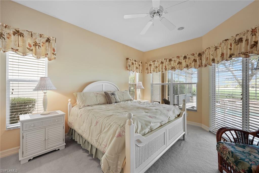 6921 Bent Grass Drive Naples, FL 34113 - Photo 16 of 48 a spacious bedroom with a bed and a window