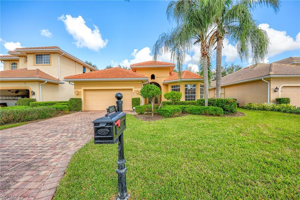 6921 Bent Grass Drive Naples, FL 34113 - Photo 2 of 48 a view of a house with a patio
