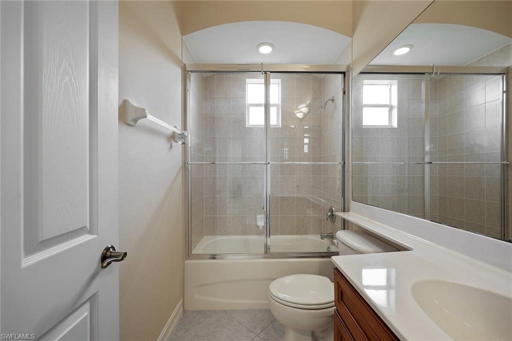 6921 Bent Grass Drive Naples, FL 34113 - Photo 22 of 48 a bathroom with a bathtub toilet and a shower