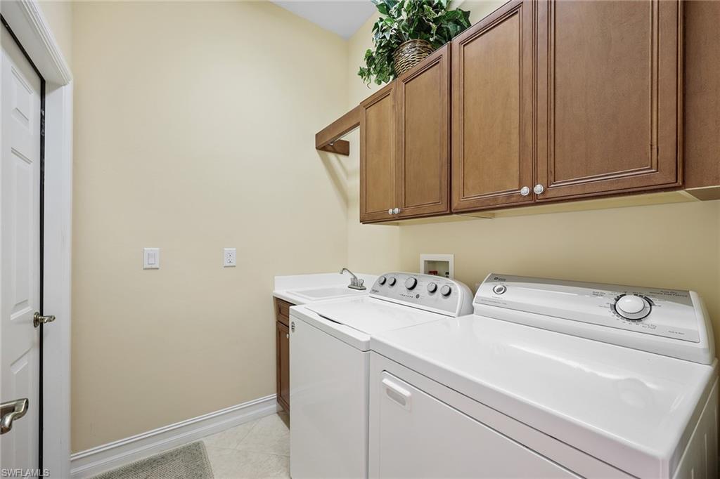6921 Bent Grass Drive Naples, FL 34113 - Photo 23 of 48 a utility room with dryer and washer