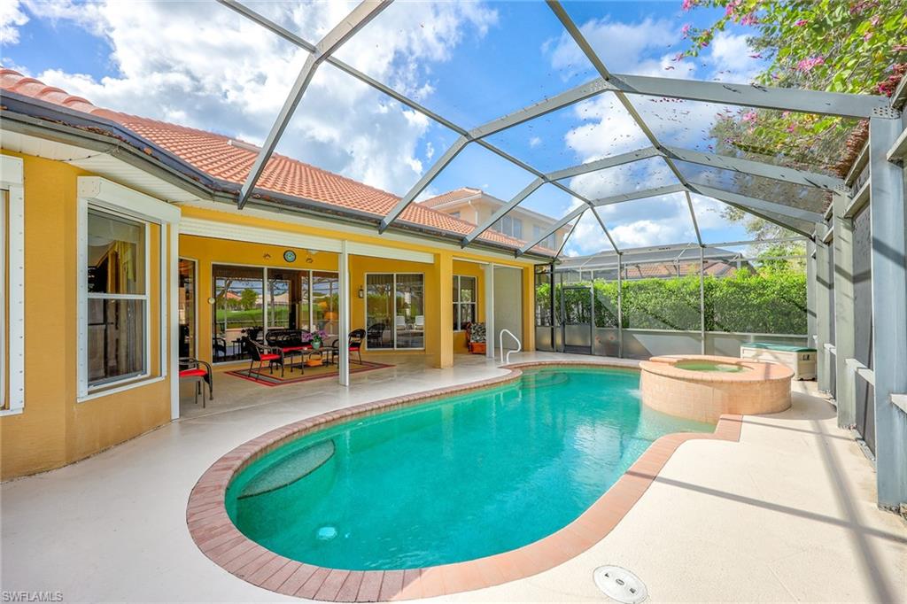 6921 Bent Grass Drive Naples, FL 34113 - Photo 27 of 48 a view of a swimming pool with back yard of a house