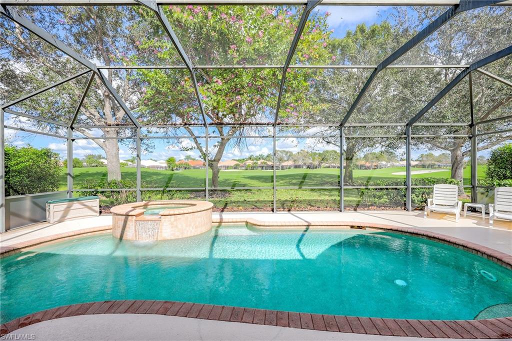 6921 Bent Grass Drive Naples, FL 34113 - Photo 28 of 48 a view of a garden with a patio