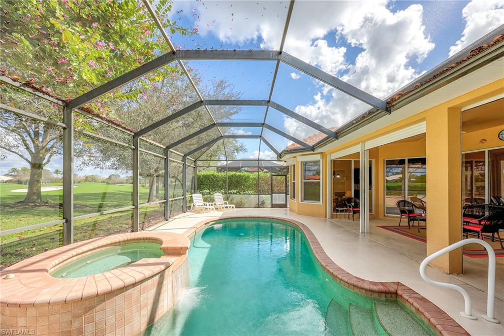 6921 Bent Grass Drive Naples, FL 34113 - Photo 30 of 48 a swimming pool with outdoor seating and yard