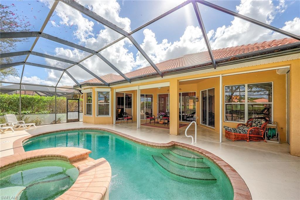 6921 Bent Grass Drive Naples, FL 34113 - Photo 31 of 48 a house view with sitting space and glass windows