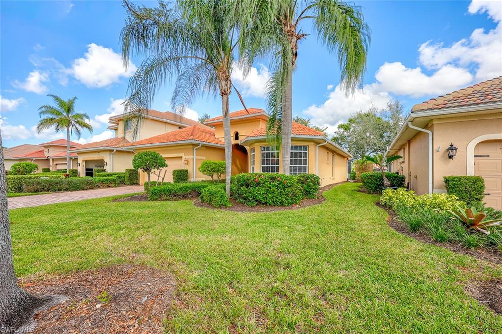 6921 Bent Grass Drive Naples, FL 34113 - Photo 33 of 48 a front view of house with yard and green space