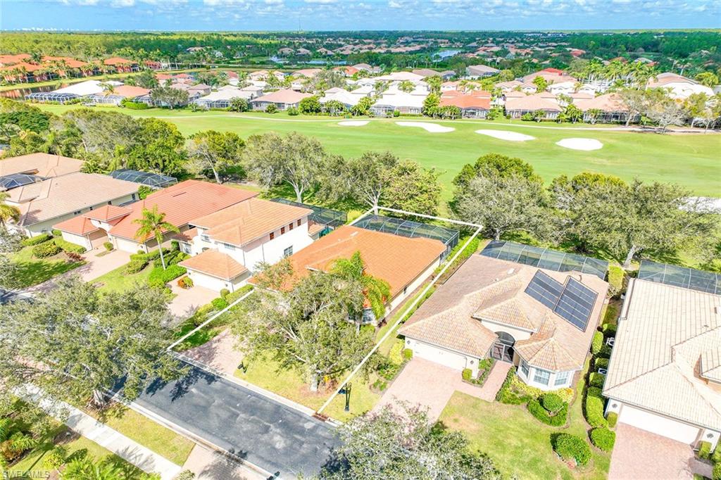 6921 Bent Grass Drive Naples, FL 34113 - Photo 39 of 48 a view of a city from a lake