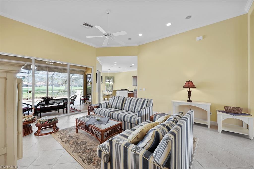 6921 Bent Grass Drive Naples, FL 34113 - Photo 8 of 48 a bedroom with furniture and a large window