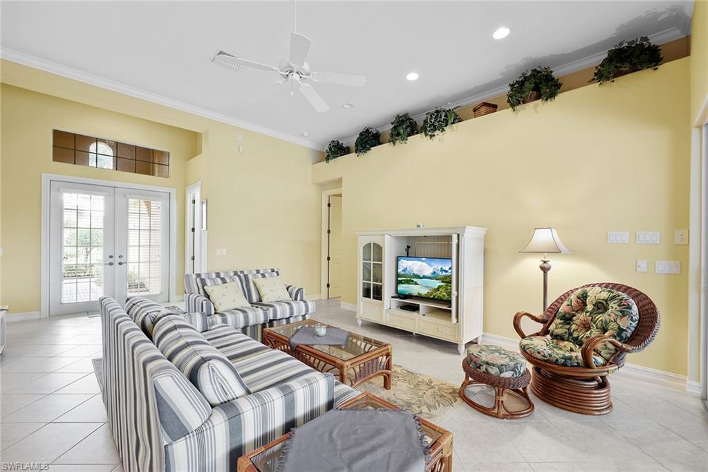 6921 Bent Grass Drive Naples, FL 34113 - Photo 10 of 48 a living room with furniture and a flat screen tv