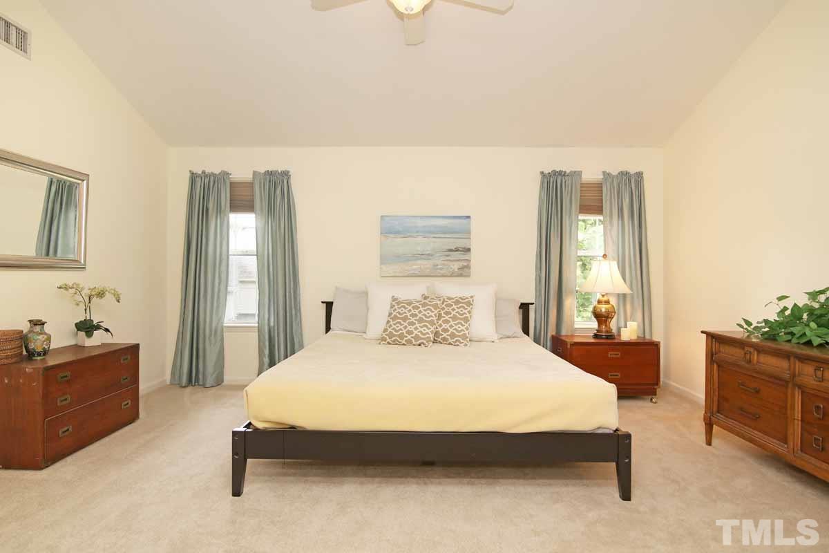 2416 Constitution Drive Raleigh, NC 27615 - Photo 14 of 25 a bedroom with a bed and a cabinets