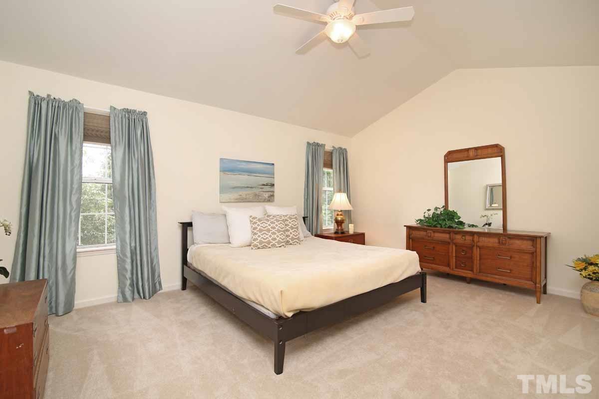 2416 Constitution Drive Raleigh, NC 27615 - Photo 15 of 25 a bedroom with a bed and a dresser
