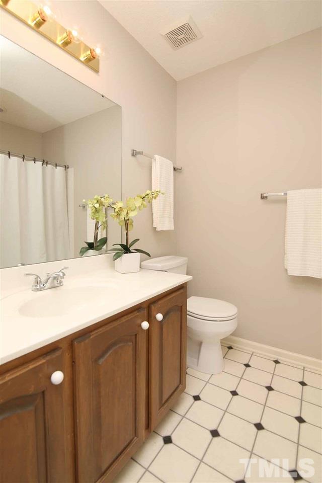 2416 Constitution Drive Raleigh, NC 27615 - Photo 21 of 25 a bathroom with a sink toilet and mirror