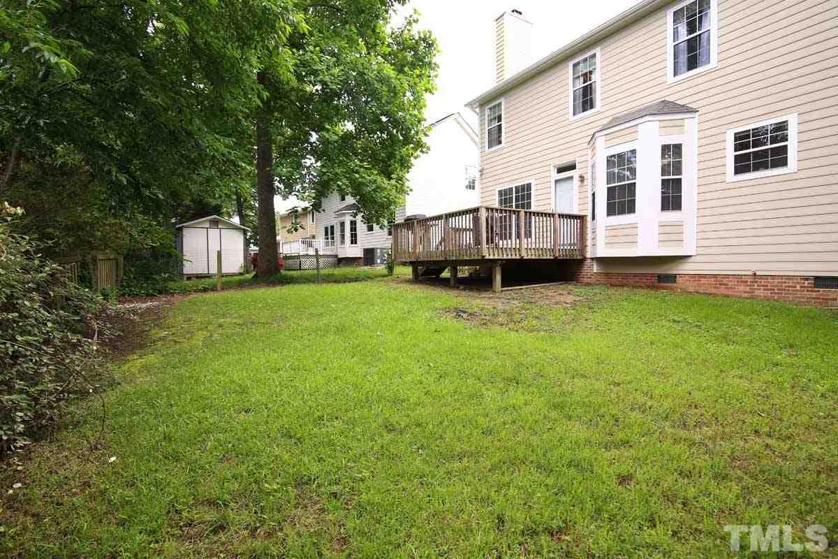 2416 Constitution Drive Raleigh, NC 27615 - Photo 23 of 25 a view of a house with a big yard and large trees