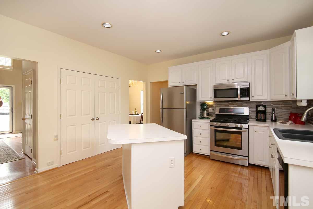 2416 Constitution Drive Raleigh, NC 27615 - Photo 5 of 25 a kitchen with stainless steel appliances granite countertop a refrigerator stove and sink