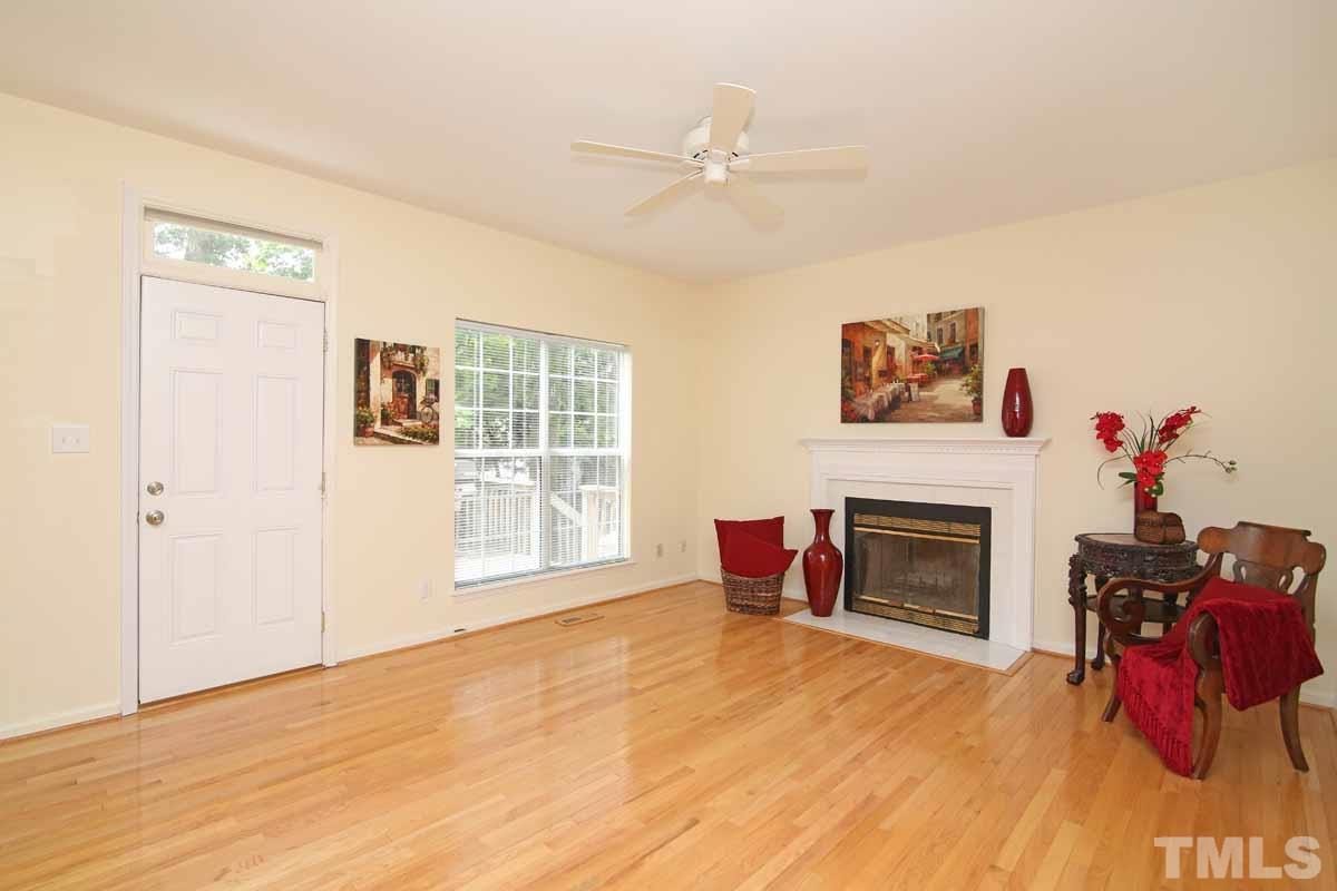 2416 Constitution Drive Raleigh, NC 27615 - Photo 8 of 25 a living room with furniture and a fireplace