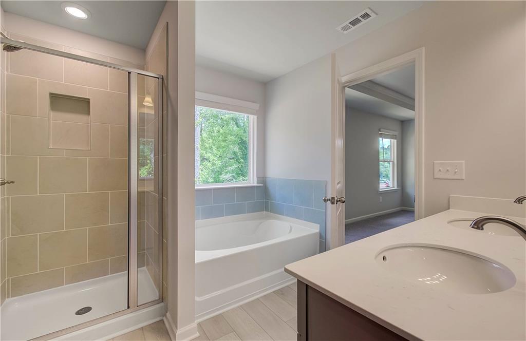 117 Alpine Road Fairburn, GA 30213 - Photo 25 of 29 a bathroom with a bathtub and a sink