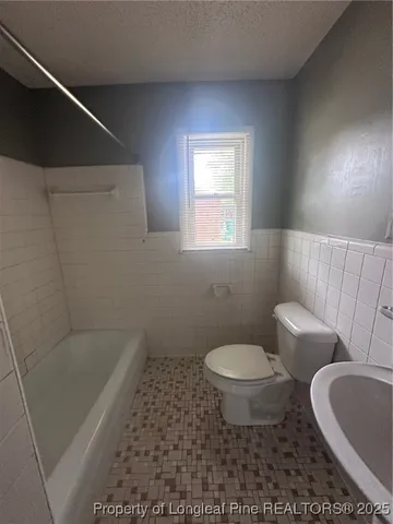 a bathroom with a toilet and a sink