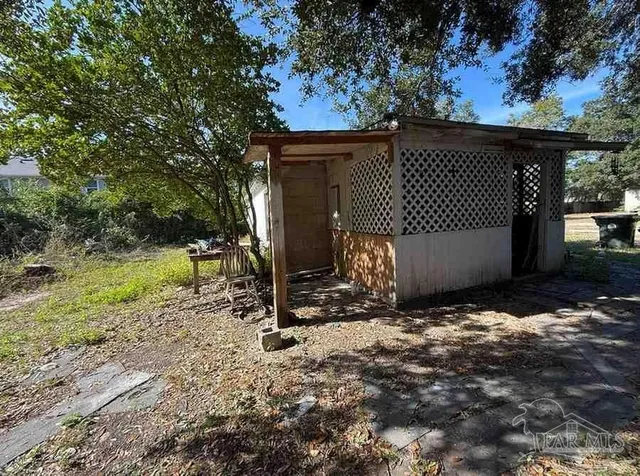 a backyard of a house with a tree