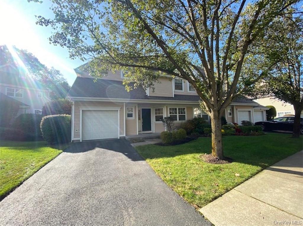 51 Winding Ridge Road White Plains, NY 10603 - Photo 2 of 30 a front view of a house with a yard and garage