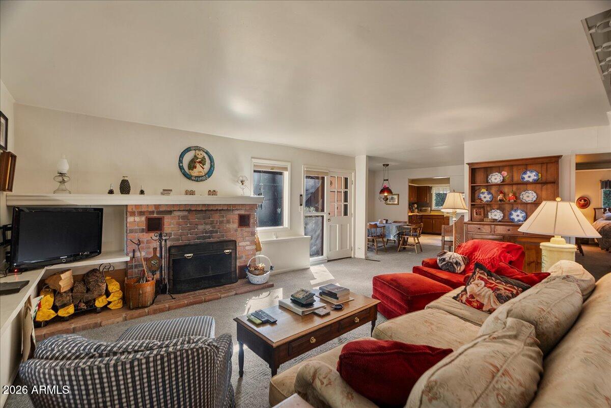 103 North Harding Drive Sedona, AZ 86336 - Photo 10 of 62 a living room with furniture a flat screen tv and a fireplace