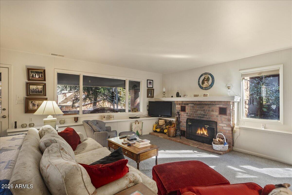 103 North Harding Drive Sedona, AZ 86336 - Photo 11 of 62 a living room with furniture and a fireplace