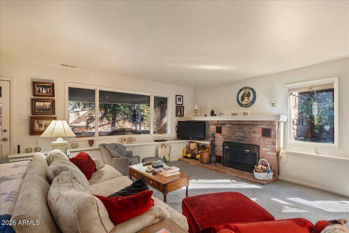 103 North Harding Drive Sedona, AZ 86336 - Photo 12 of 62 a living room with furniture and a fireplace