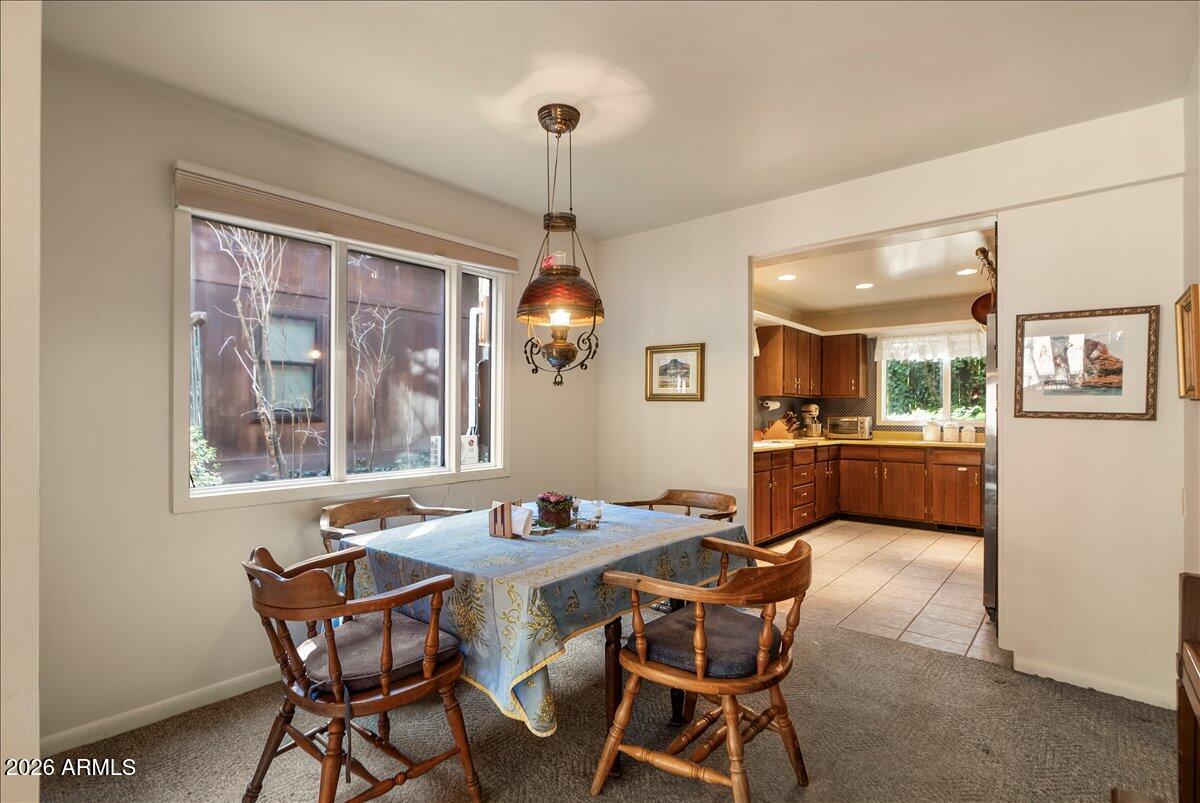 103 North Harding Drive Sedona, AZ 86336 - Photo 15 of 62 a view of a dining room with furniture large windows and wooden floor