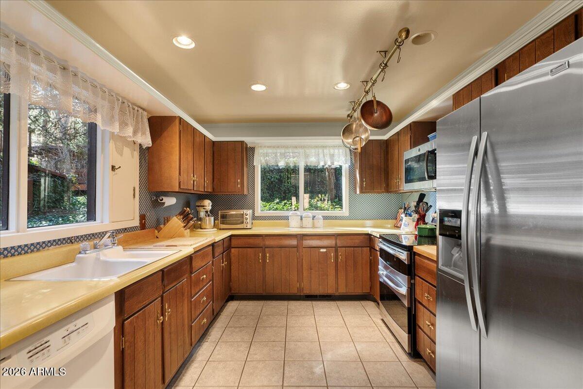 103 North Harding Drive Sedona, AZ 86336 - Photo 18 of 62 a large kitchen with stainless steel appliances granite countertop sink stove and refrigerator
