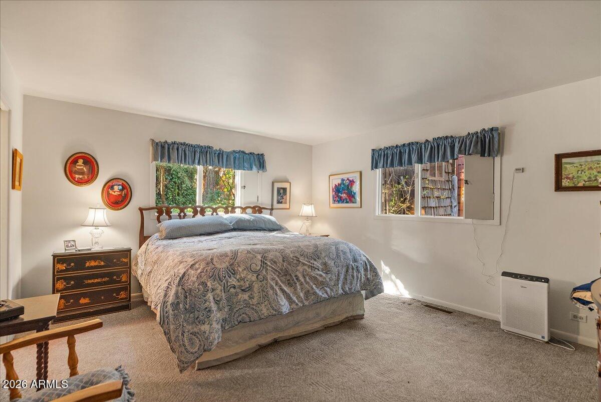 103 North Harding Drive Sedona, AZ 86336 - Photo 21 of 62 a spacious bedroom with a bed and a window