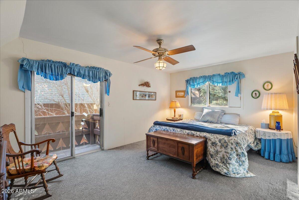103 North Harding Drive Sedona, AZ 86336 - Photo 29 of 62 a spacious bedroom with a bed a chandelier and a window