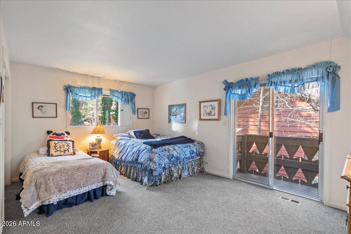 103 North Harding Drive Sedona, AZ 86336 - Photo 33 of 62 a spacious bedroom with two beds and a window