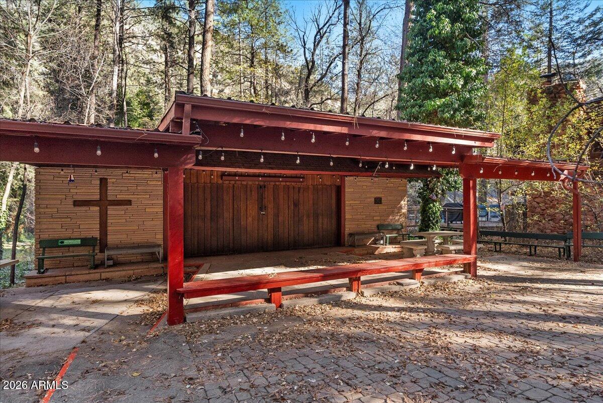 103 North Harding Drive Sedona, AZ 86336 - Photo 43 of 62 a backyard of a house with barbeque oven and wooden fence